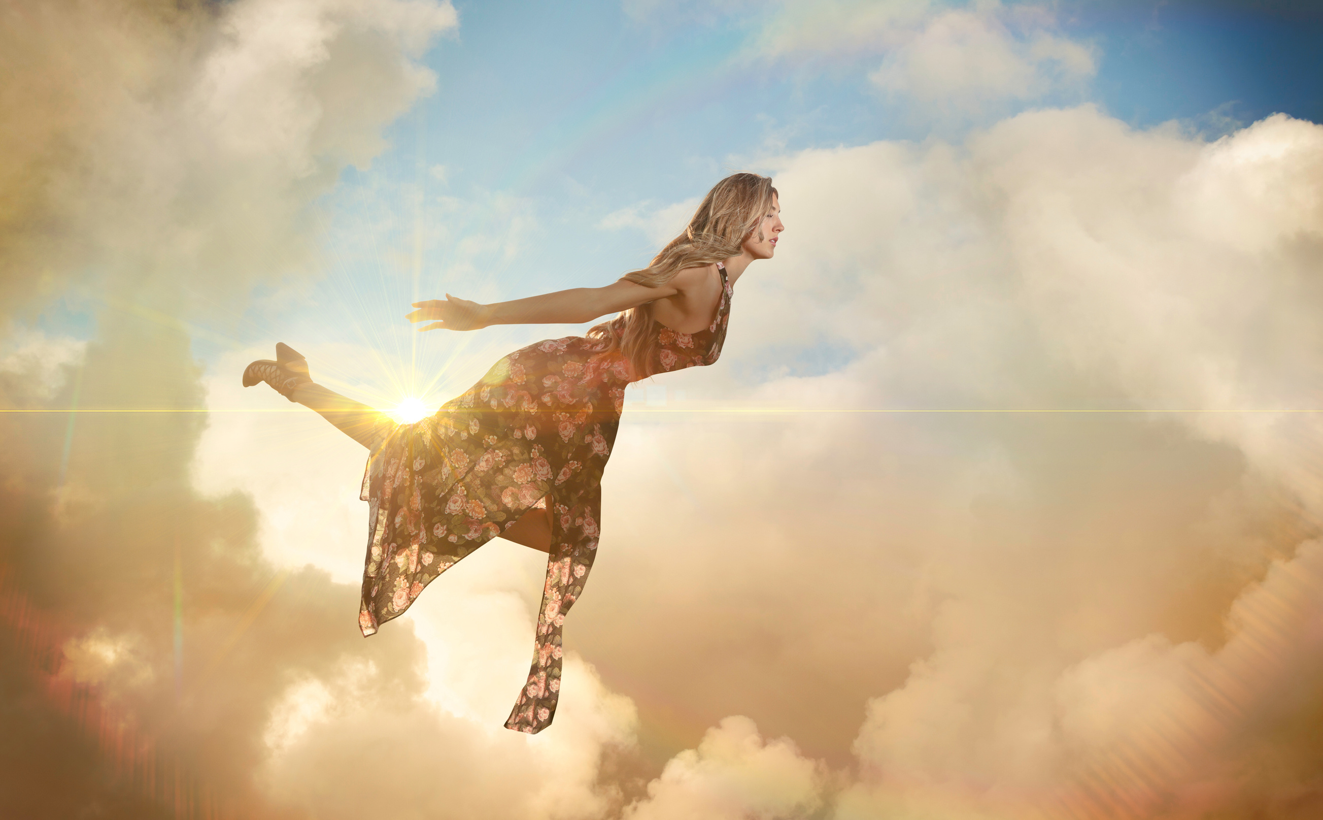 Magical floating woman floating in clouds